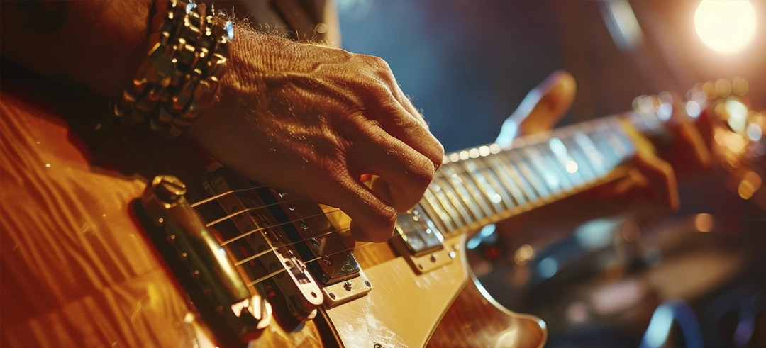 Persona tocando una guitarra eléctrica